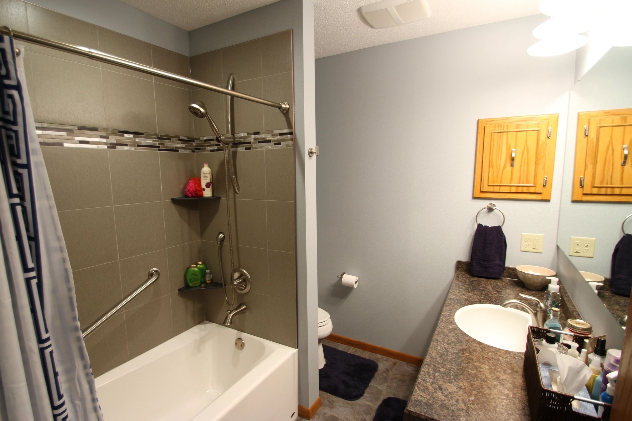 Bathroom with shower and vanity mirror