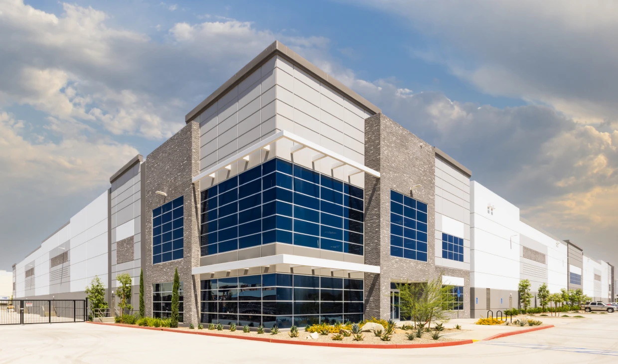 Contemporary warehouse structure under cloudy sky